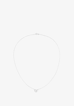 Sidabro pakabukas su plona grandinėle ir apvaliu pendantu, kuriame yra susipynę kilpos. Dizainas minimalistiškas ir glotnus.
