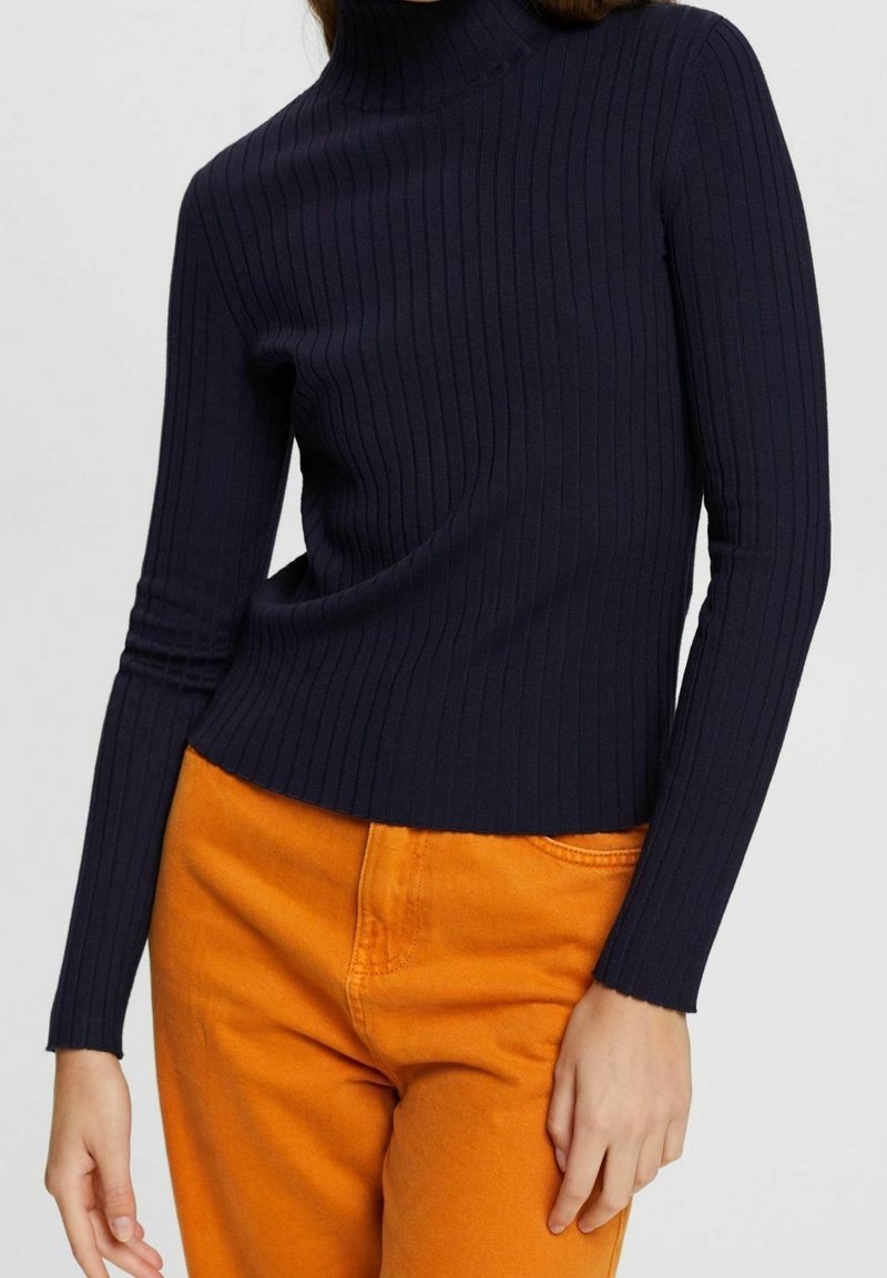 Marineblauer, gerippter Rollkragenpullover mit langen Ärmeln; aus weichem, dehnbarem Stoff; cropped Design mit figurbetonter Silhouette.