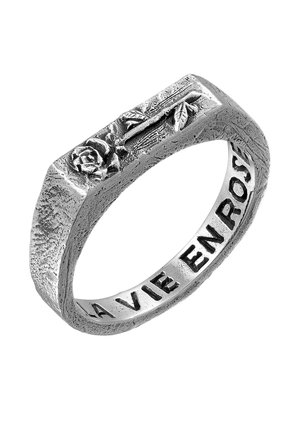 Sterling silver ring with a flat design, featuring a raised rose motif on one side and engraved text "LA VIE EN ROSE" on the interior surface.