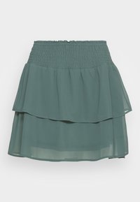 Green layered chiffon skirt with a smocked waistband. Features two tiers, soft texture, and a subtle flowy design.