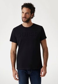 Guess - PRÄGE-LOGO - Marškinėliai su spaudiniu - schwarz Miniatiūros vaizdas 1