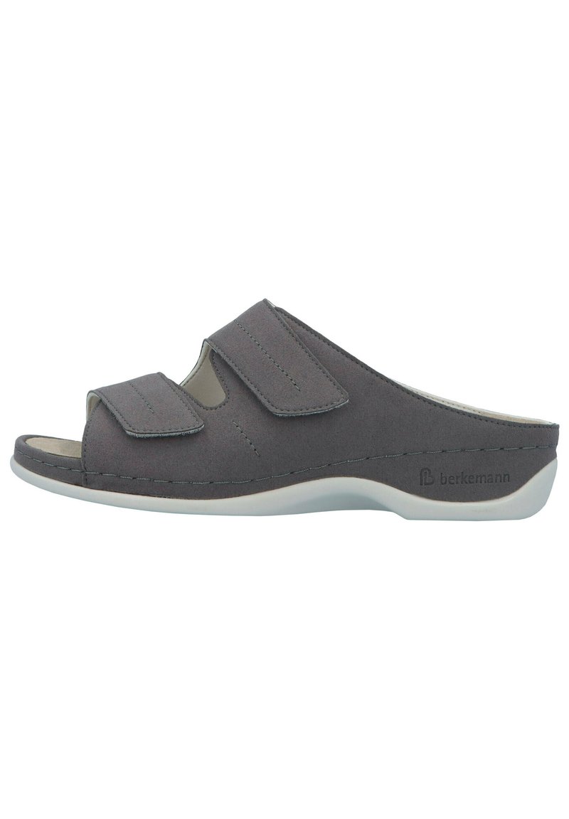 Gray slip-on sandal featuring two adjustable Velcro straps, a cut-out design, and a textured surface on a white sole.