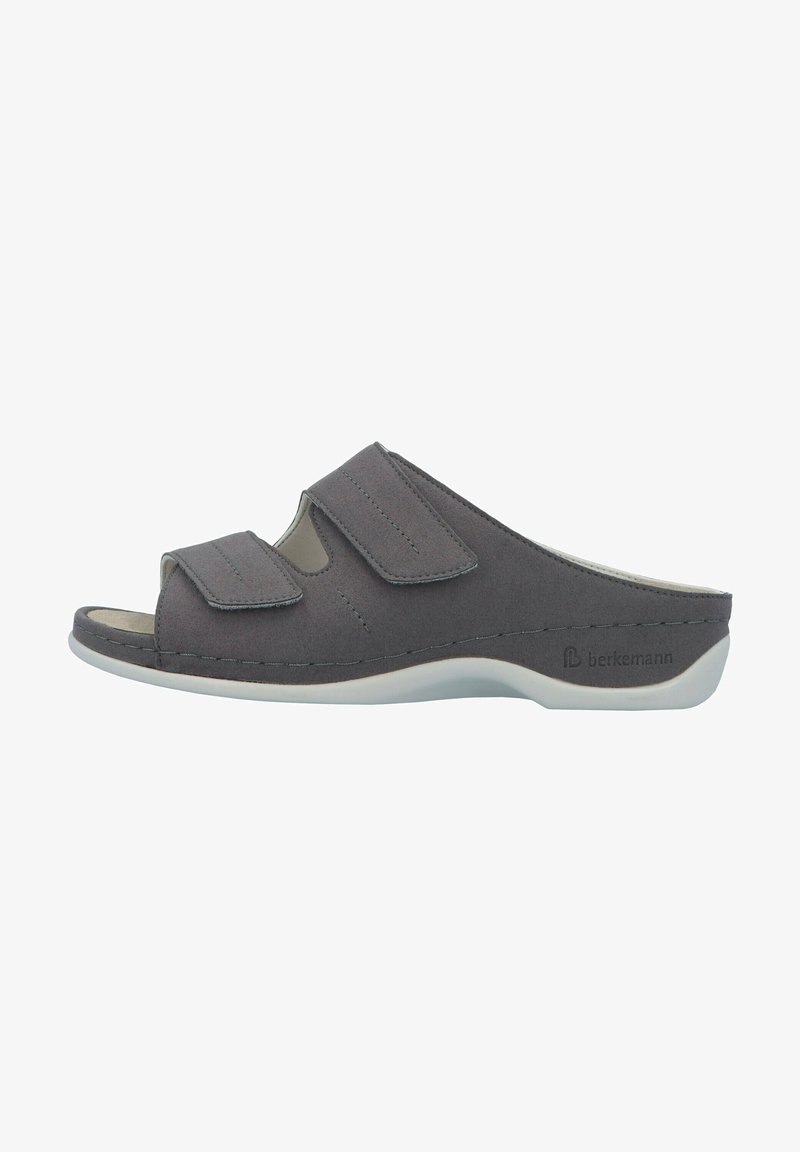 Gray slip-on sandal featuring two adjustable Velcro straps, a cut-out design, and a textured surface on a white sole.