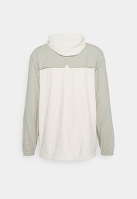 Rains STORM BREAKER UNISEX - Casaco impermeável - fossil cement