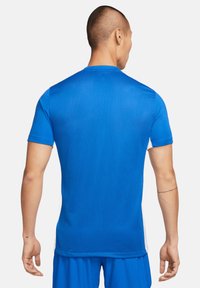 Blauw sportieve t-shirt met een textuurstof, korte mouwen en een ronde hals. Inclusief witte zijaccenten en een rechte zoom.