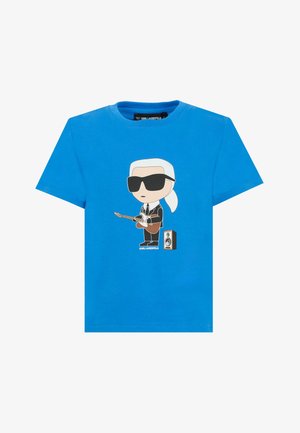 Maglietta blu con cartone animato di una persona con occhiali da sole e completo che suona la chitarra accanto a un altoparlante, testo "KARL LAGERFELD" sotto.