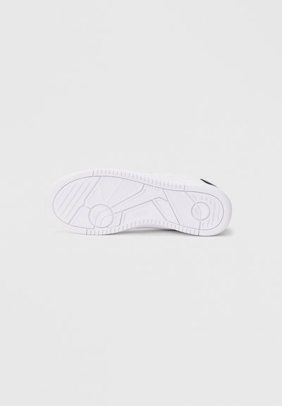 Bijeli đon tenisice s geometrijskim uzorkom gaznoga sloja i utisnutim natpisom "Polo" u centru, prikazan na jednostavnoj svijetloj pozadini.