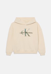 Felpa in cotone beige con un logo grafico "CK" in blu e verde, con il testo "Calvin Klein Jeans" sotto. Include un cappuccio con cordino.
