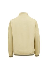 Beige leichte Jacke mit Stehkragen, elastischen Bündchen und geripptem Saum mit schwarz-weißen Streifen. Glatte Textur und minimales Design.