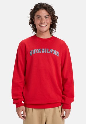 Červená mikina vyrobená z bavlnenej zmesi, s okrúhlym výstrihom a dlhými rukávmi, na hrudi s modrým textom "QUIKSILVER".