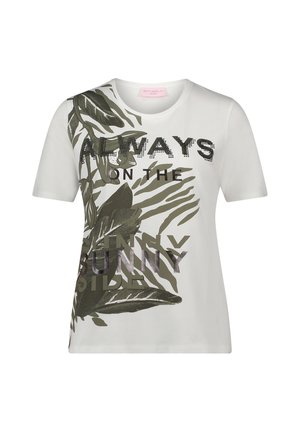 T-shirt blanc avec motifs de feuilles vertes et un design de texte imprimé. Agrémenté d'accents brillants, il présente un col rond et des manches courtes.