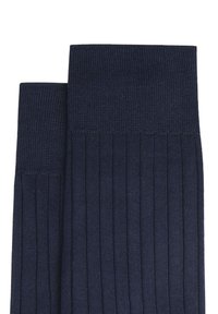 Calze a coste blu navy con una morbida trama a maglia, caratterizzate da un colore uniforme e un ampio bordo superiore per comfort e aderenza.