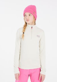 Lichtbeige lange mouwen zip-top met hoge kraag en logo-detail, gecombineerd met felroze broek en een gemêleerde roze gebreide muts.