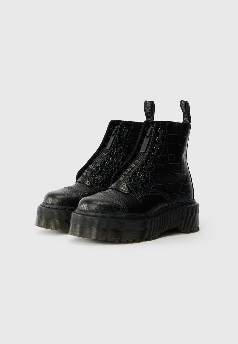 Black ankle boots made of croc-embossed leather, featuring side zippers, thick rubber sole, and pull tabs for easy wear.