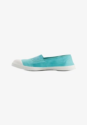 Chaussure en toile bleu clair à enfiler avec semelle en caoutchouc blanche et embout, vue de profil sur fond blanc.