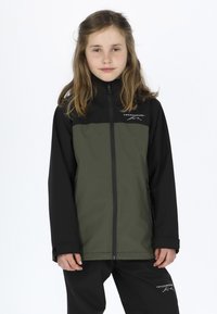 Green and black softshell jacket with zip front, high collar, and logo, paired with black pants. Smooth texture, casual fit.