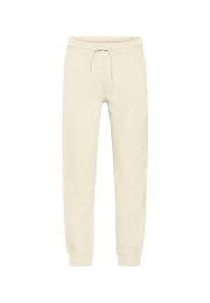 Krém színű melegítőnadrág bordázott textúrával, rugalmas derékpánttal, állítható zsinórral és szűk szabású bokarészre.