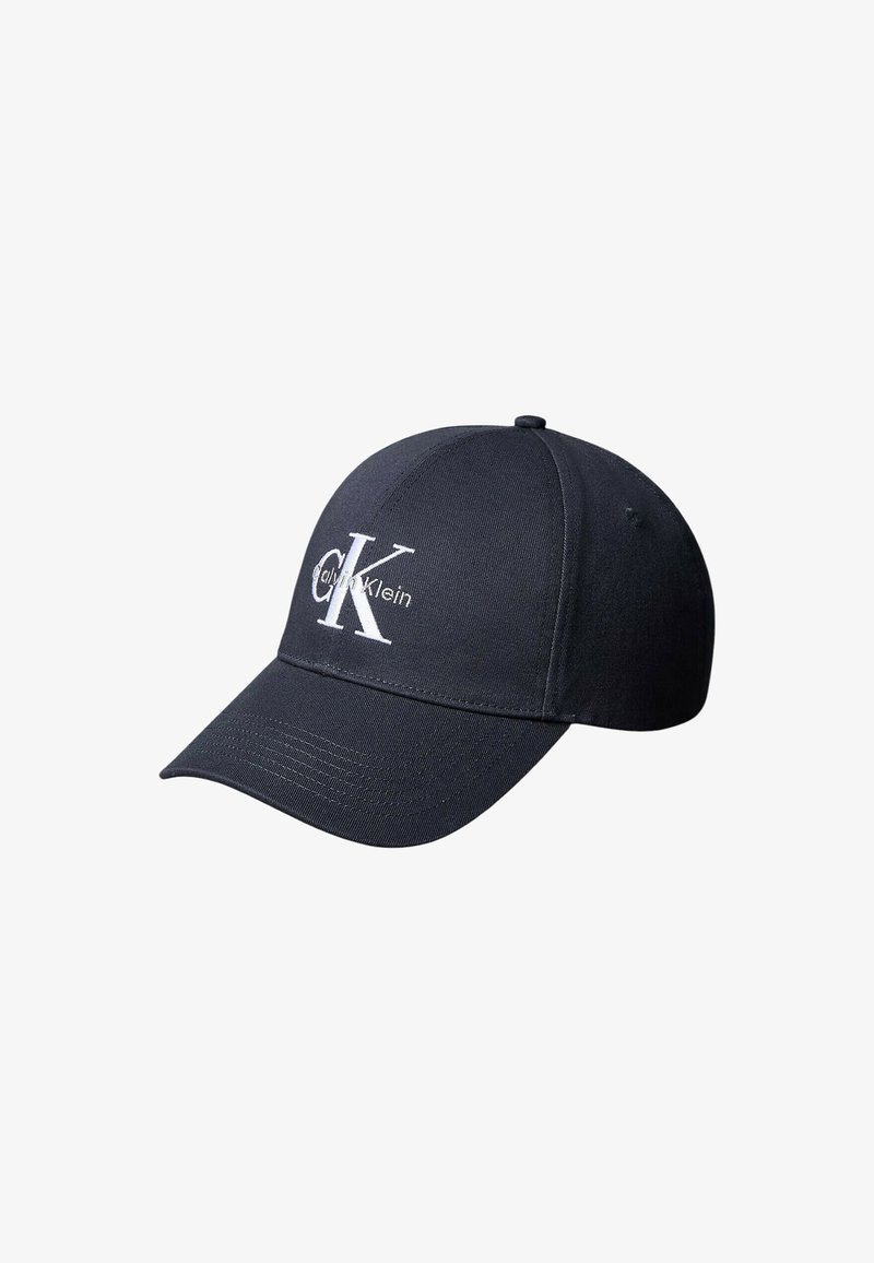 Casquette de baseball noire à visière incurvée, avec le logo brodé blanc "cK" et "Calvin Klein" sur le devant.