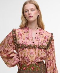 Bluză florală roz cu accente verzi. Dispune de guler volănaș, închidere cu butoane și mâneci lungi cu o croială lejeră. Modele botanice detaliate.