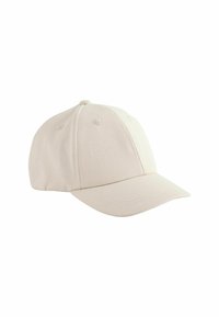 Gorra de béisbol de algodón beige con visera curvada, diseño de seis paneles y ojales bordados para ventilación. Presenta una textura suave.
