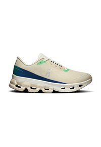 Neutral running shoe with a beige mesh upper, green and blue accents, featuring a cushioned sole with distinctive cutouts for support.