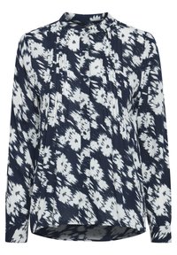 Blouse marine et blanche avec un design à motifs, plis à l'avant, manches longues et col montant. Fermeture par boutons sur le devant.