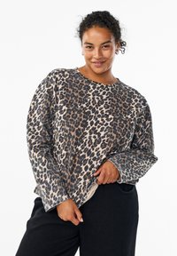 Leopard-print sweatshirt with long sleeves, round neckline, and a soft texture. Features a beige base with dark brown and black spots.