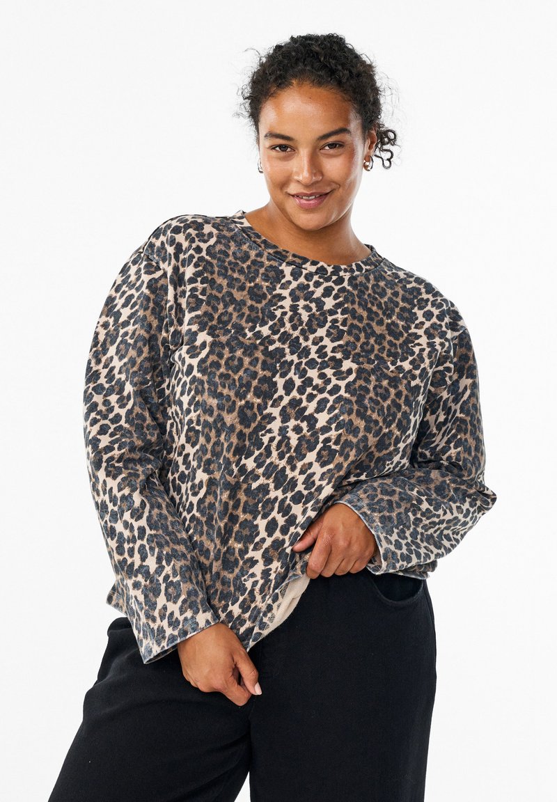 Leopard-print sweatshirt with long sleeves, round neckline, and a soft texture. Features a beige base with dark brown and black spots.