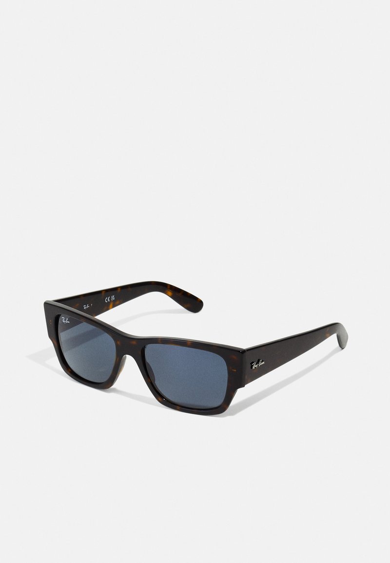 Ochelari de soare tortoise brown cu rame pătrate, lentile întunecate și un design elegant. Logo-ul mărcii afişat pe braţul lateral.