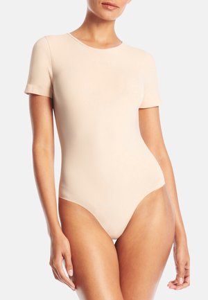 Nude short-sleeve bodysuit in a smooth, stretchy fabric with a fitted design, featuring a crew neckline and high-cut leg openings.