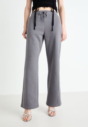 Gray sweatpants with a relaxed fit, made from soft fabric, featuring a drawstring waist and side seams for added detail.