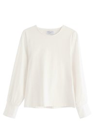 Blusa bianca a maniche lunghe con scollatura rotonda e maniche arricciate, realizzata in tessuto morbido. L'orlo scende sotto la vita, design minimalista.
