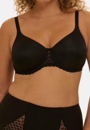 Woman wearing a black underwire bra and matching high-waisted bottoms with lace detailing at the front.
