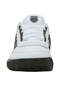 Bílé sportovní boty s černými pruhy, texturovanou gumovou podrážkou a bílými tkaničkami. Logo K-Swiss na jazyku. Strukturovaný design pro stabilitu.