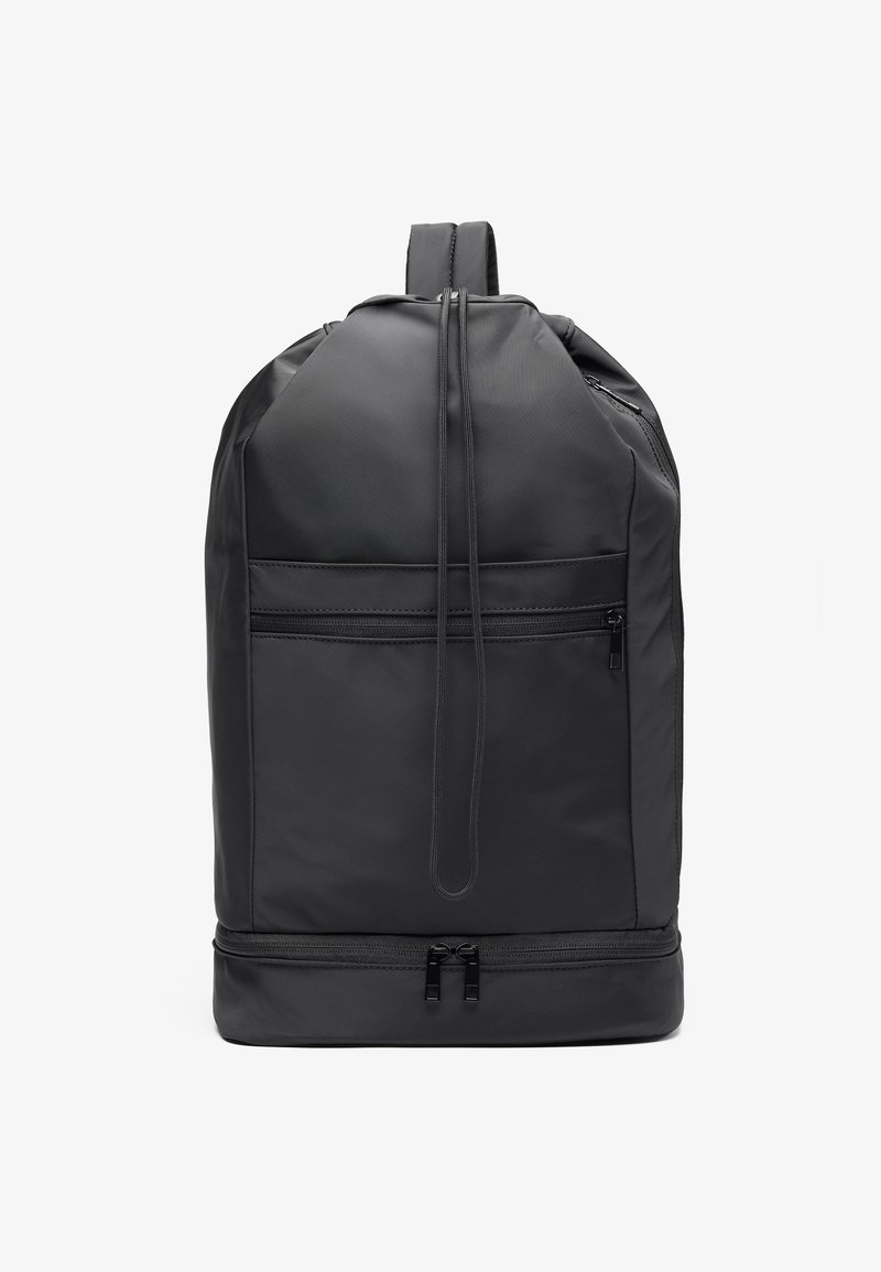 Black nylon backpack with a rounded shape, featuring a front zipper pocket, adjustable straps, and a smooth texture. Double zipper at the bottom.
