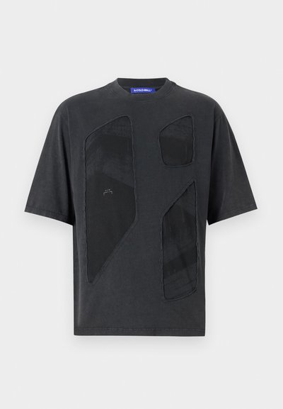 Dark gray short-sleeve t-shirt featuring large cut-out patches with a textured pattern and contrasting black accents. Round neckline.