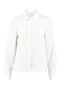 Blusa bianca a maniche lunghe con colletto e patta frontale coperta, caratterizzata da bottoni rivestiti in tessuto.