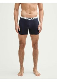 Boxer-briefs bleu marine avec une ceinture élastique douce arborant "TOM TAILOR" en lettres blanches, conçues pour le confort et l'ajustement.