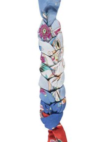 Pleciony szalik wyróżnia się niebieskim i czerwonym materiałem z kwiatowymi wzorami, gładką teksturą oraz połączeniem jednolitych i wzorzystych sekcji.