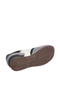Sneaker featuring a white upper with gray and black accents, textured rubber sole, and contrasting stitching. Logo visible on the side.