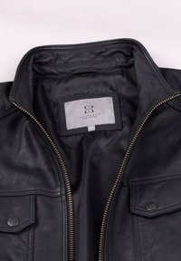 Black leather jacket with a zip closure, snap button pockets, and a smooth interior lining. Label displays "Lakeland Fine Leather" and size 42.