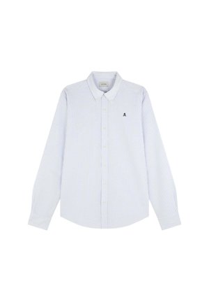 Chemise à rayures bleues et blanches à manches longues avec un col boutonné, présentant un logo de crâne brodé sur la poitrine gauche. Tissu en coton.