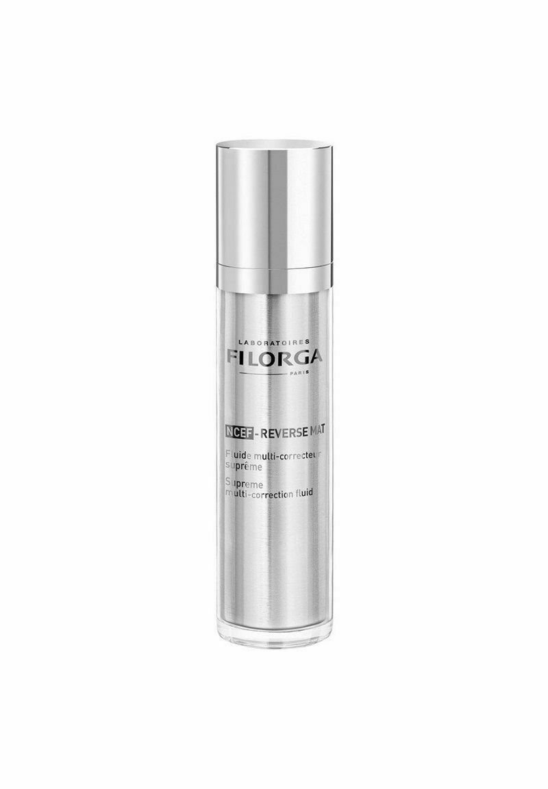 Clear glass bottle with a silver pump cap. Label includes “Laboratoires FILORGA” and product details in black text on the front.