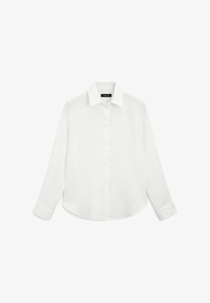 Chemise blanche à manches longues avec col, boutons sur le devant et ourlet arrondi. Fabriquée en tissu léger au toucher lisse.