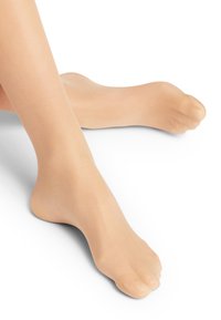 Collant beige traslucido senza punta che copre le gambe, caratterizzato da una texture liscia e un aspetto trasparente, che mette in risalto le dita dei piedi.