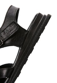 Sandalo in pelle nera con cinturini regolabili e suola spessa, progettato per comfort e supporto casual.