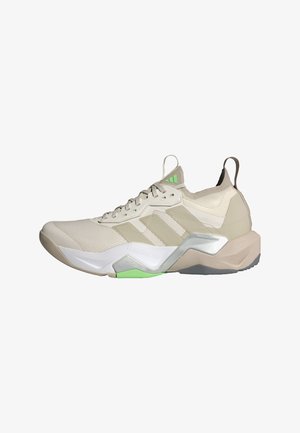 Beige athletic shoe with mesh upper, three white stripes, green accents, and textured sole. Features a pull tab on the heel and light cushioning.