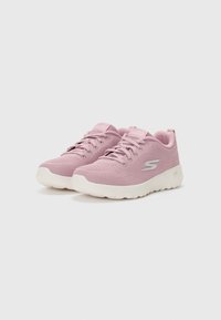 Pink mesh sneakers with white rubber soles, featuring flat laces and a small logo on the side. Textured upper for breathability.
