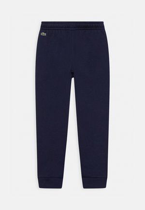 Pantaloni da tuta blu navy con vita e polsini elasticizzati. Presentano un piccolo logo verde vicino alla cintura. Realizzati in un materiale morbido e elasticizzato.