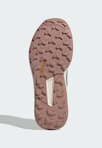 Semelle de chaussure d'extérieur avec une surface en caoutchouc brun texturé présentant un motif de bande de zigzag et une accent crème. Marque Continental visible.